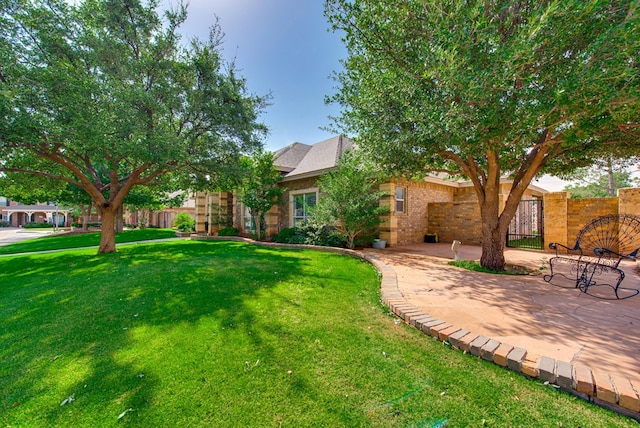 4609 Woodbar Ct, Midland, TX 79707 - obstructed view of property with brick siding and a patio area