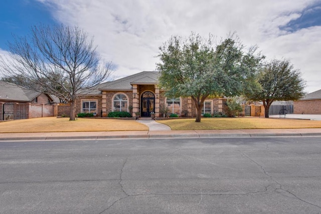 view of front of property with a front lawn and fence