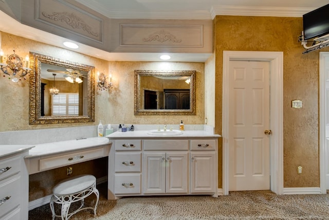 bathroom with ornamental molding, vanity, and baseboards