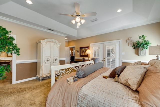 carpeted bedroom with access to exterior, visible vents, a tray ceiling, and french doors