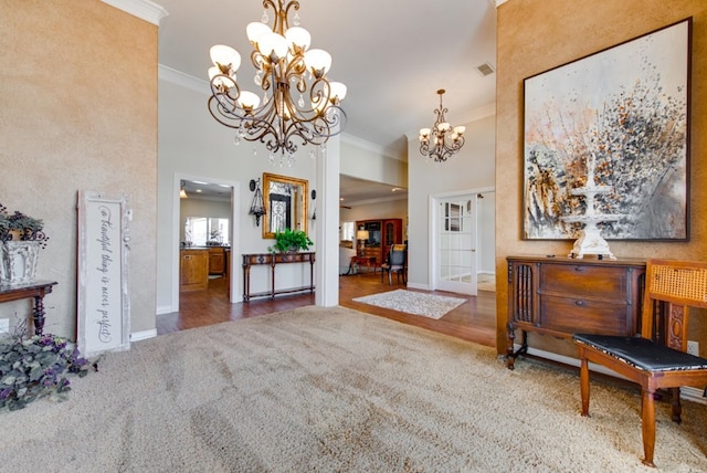 entrance foyer with carpet, wood finished floors, a towering ceiling, and crown molding