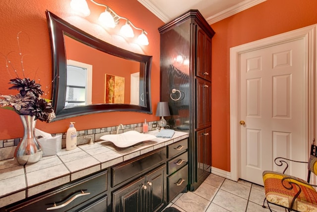 bathroom with ornamental molding, tile patterned flooring, and vanity