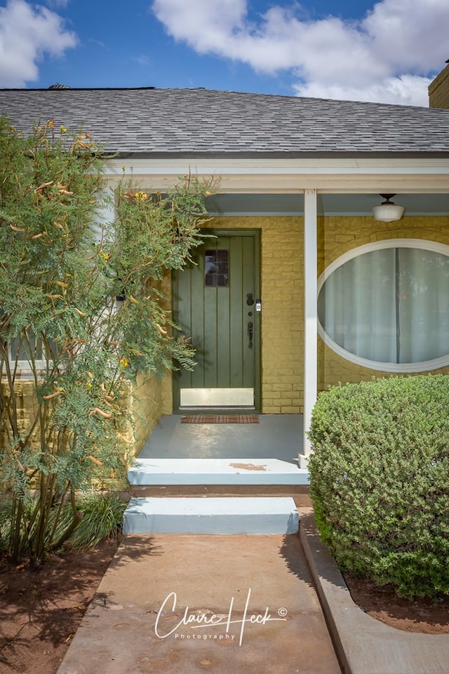 1700 Holloway Ave, Midland, TX 79701 - entrance to property with brick siding, a shingled roof, and a porch