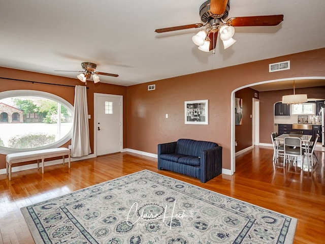 1700 Holloway Ave, Midland, TX 79701 - living area featuring ceiling fan, arched walkways, and wood finished floors