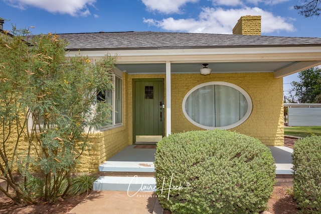 1700 Holloway Ave, Midland, TX 79701 - doorway to property with a chimney, a porch, and roof with shingles