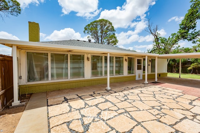 1700 Holloway Ave, Midland, TX 79701 - back of house with a patio, a chimney, and brick siding