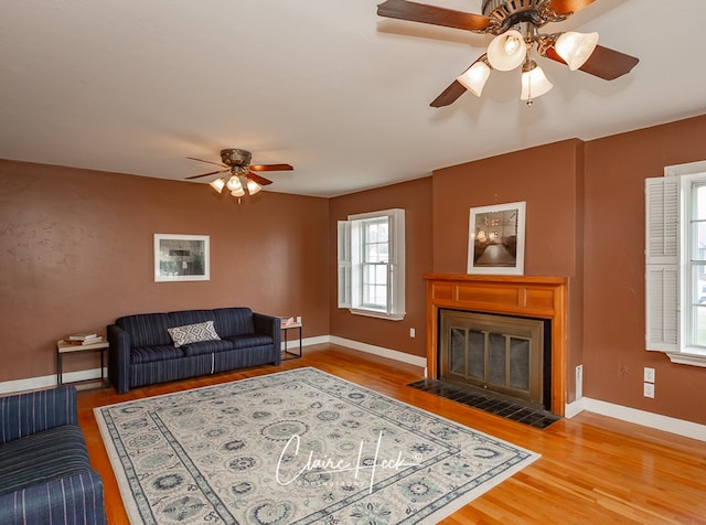 1700 Holloway Ave, Midland, TX 79701 - living area featuring ceiling fan, wood finished floors, and a fireplace with flush hearth