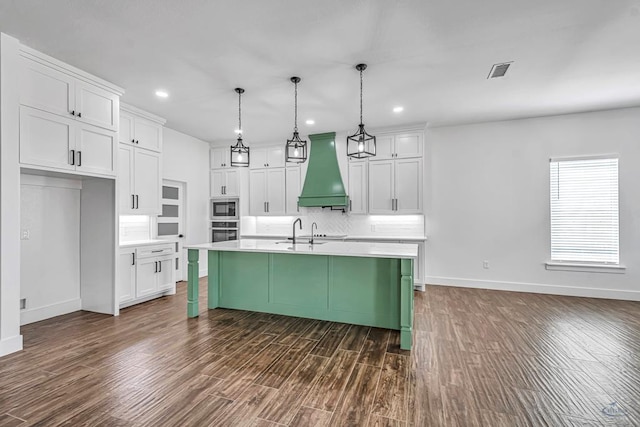 2200 S County Rd 1059, Midland, TX 79706 - kitchen featuring baseboards, visible vents, appliances with stainless steel finishes, and premium range hood