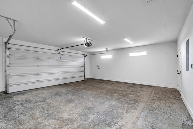 2200 S County Rd 1059, Midland, TX 79706 - garage featuring baseboards and a garage door opener