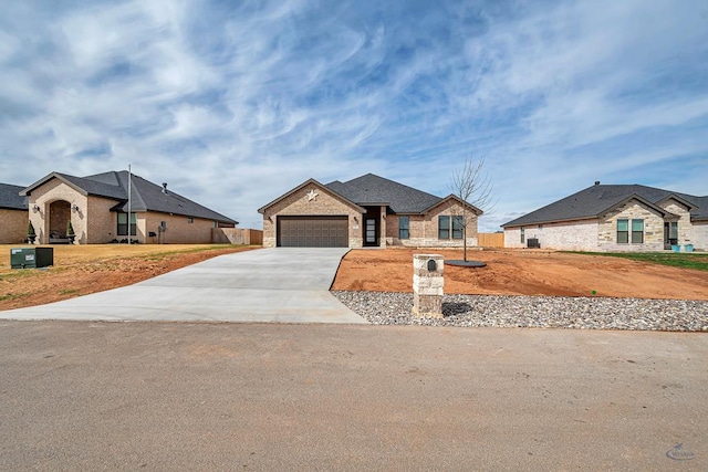 2200 S County Rd 1059, Midland, TX 79706 - ranch-style home with driveway, brick siding, an attached garage, and stone siding