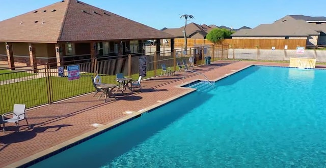 view of pool with a yard and a patio area