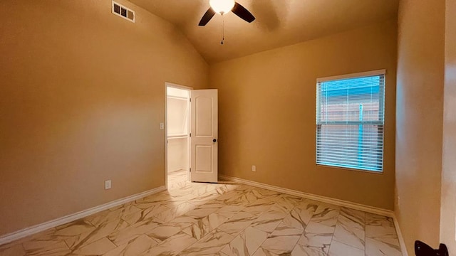 unfurnished room with ceiling fan and vaulted ceiling