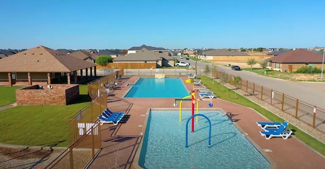 view of swimming pool featuring a patio area and a lawn