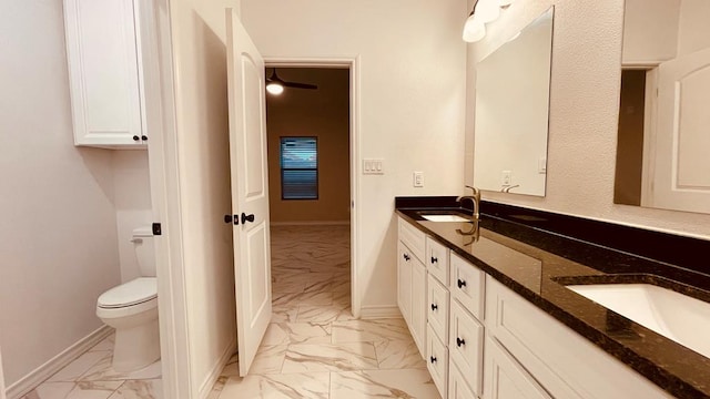 bathroom with ceiling fan, vanity, and toilet