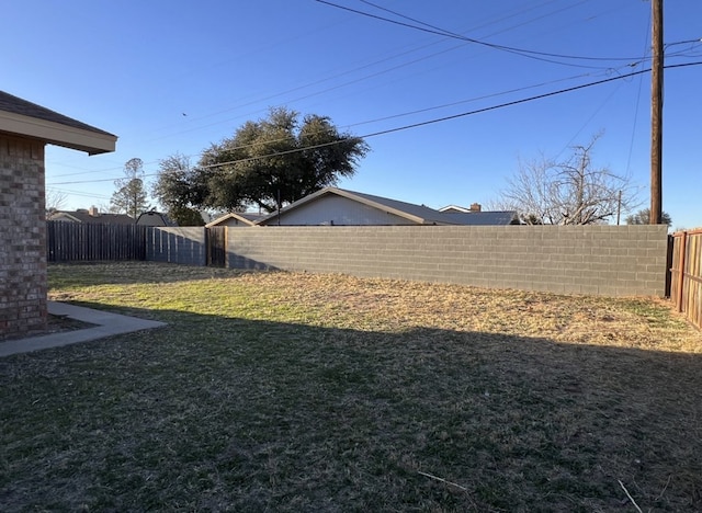 view of yard with a fenced backyard