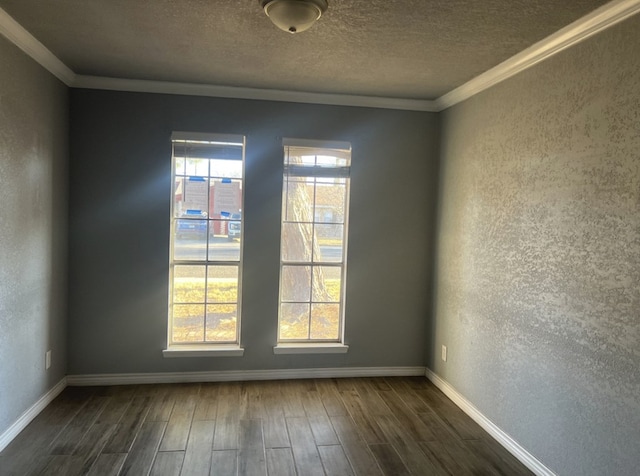 unfurnished room featuring a textured wall, dark wood-type flooring, a wealth of natural light, and crown molding