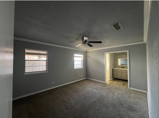 unfurnished bedroom featuring ornamental molding, carpet flooring, and visible vents