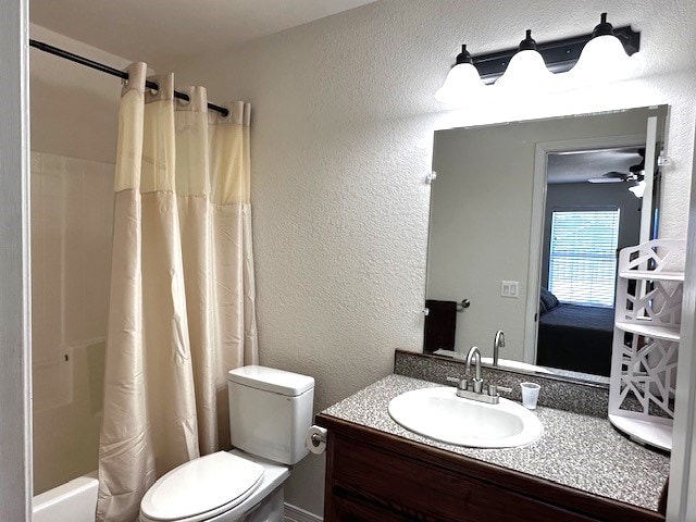 full bathroom with ceiling fan, shower / bath combo with shower curtain, vanity, and toilet