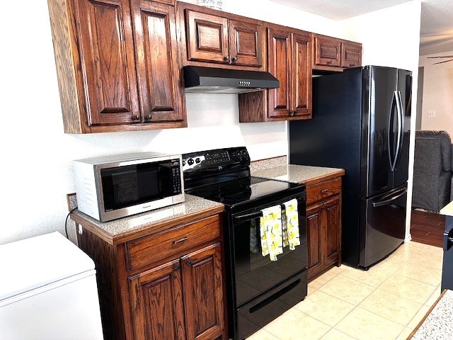 kitchen with black appliances, ceiling fan, light tile patterned flooring, and extractor fan