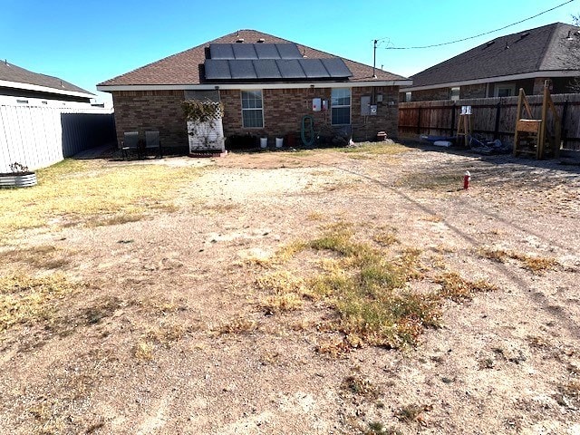 rear view of house with solar panels