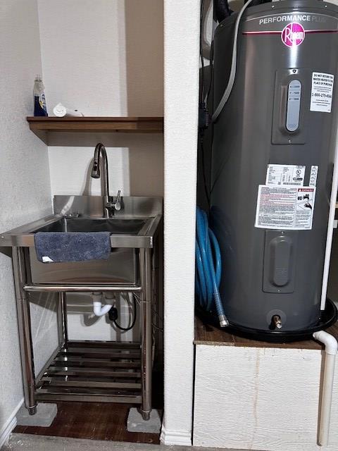 room details featuring electric water heater and sink