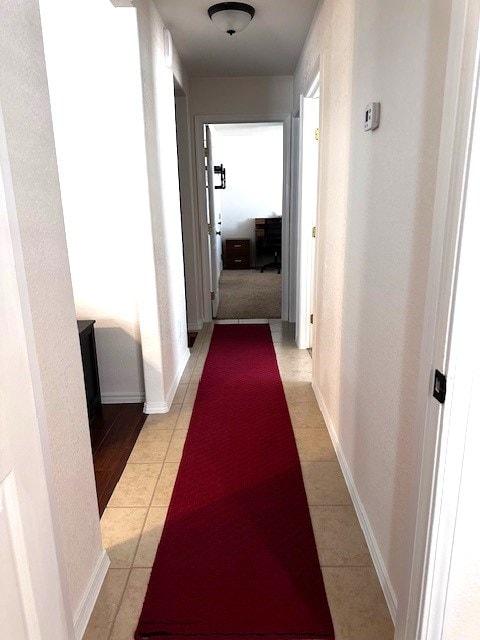 corridor featuring light tile patterned flooring