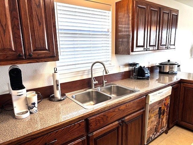 kitchen featuring white dishwasher, dark brown cabinetry, sink, and light tile patterned floors