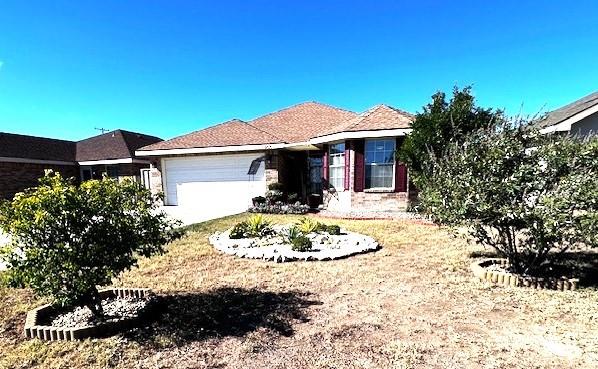 ranch-style home featuring a garage