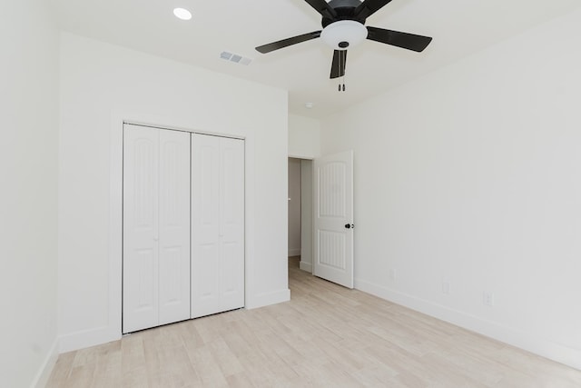 unfurnished bedroom with a closet, ceiling fan, and light hardwood / wood-style flooring