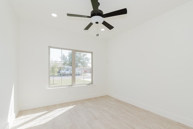 unfurnished room with ceiling fan and light wood-type flooring