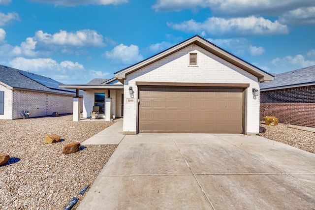 1109 Cajun St, Odessa, TX 79765 - ranch-style house with brick siding, concrete driveway, and an attached garage