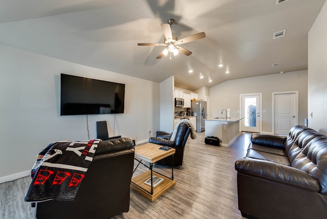 1109 Cajun St, Odessa, TX 79765 - living area featuring vaulted ceiling, light wood-style floors, and ceiling fan