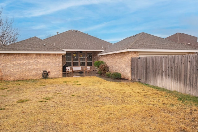 rear view of house featuring a lawn