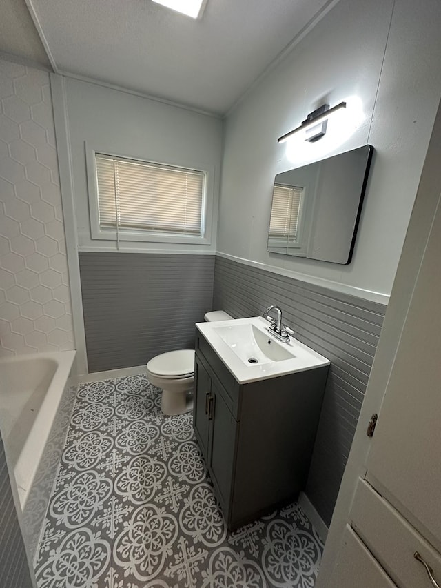 bathroom featuring a bathing tub, tile patterned flooring, vanity, and toilet