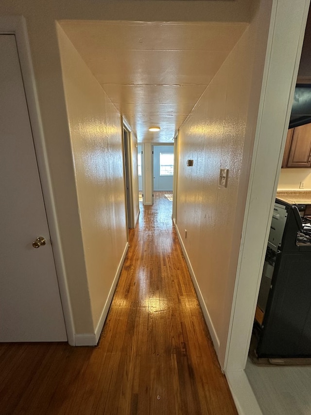 hallway with dark hardwood / wood-style flooring