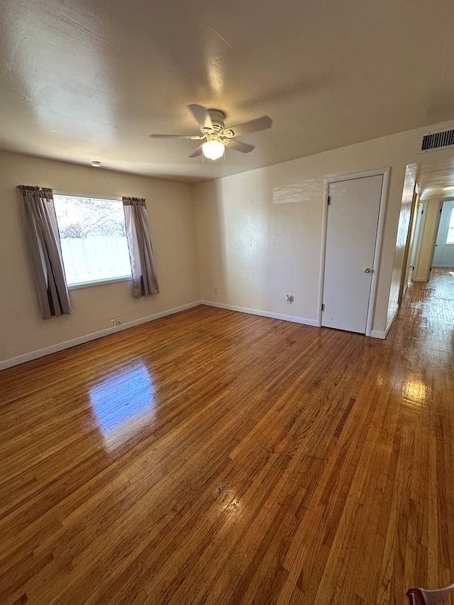 unfurnished room with ceiling fan and wood-type flooring