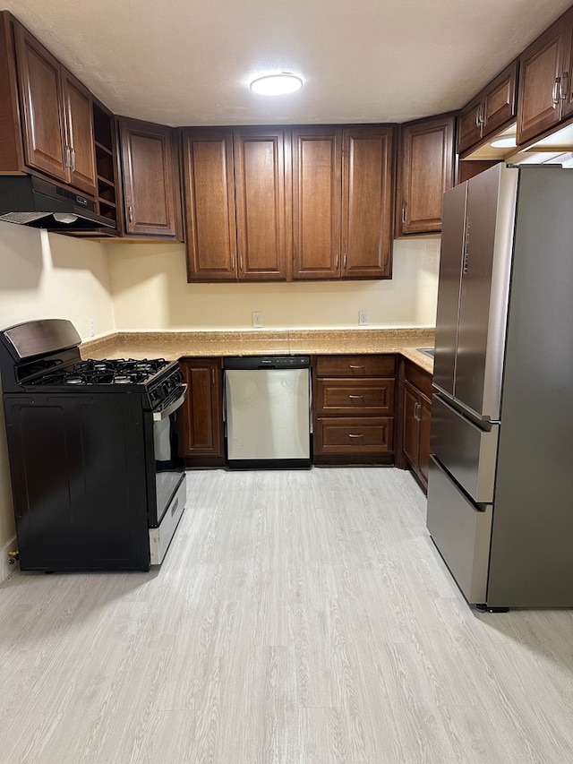 kitchen with light hardwood / wood-style flooring, exhaust hood, dark brown cabinets, and appliances with stainless steel finishes