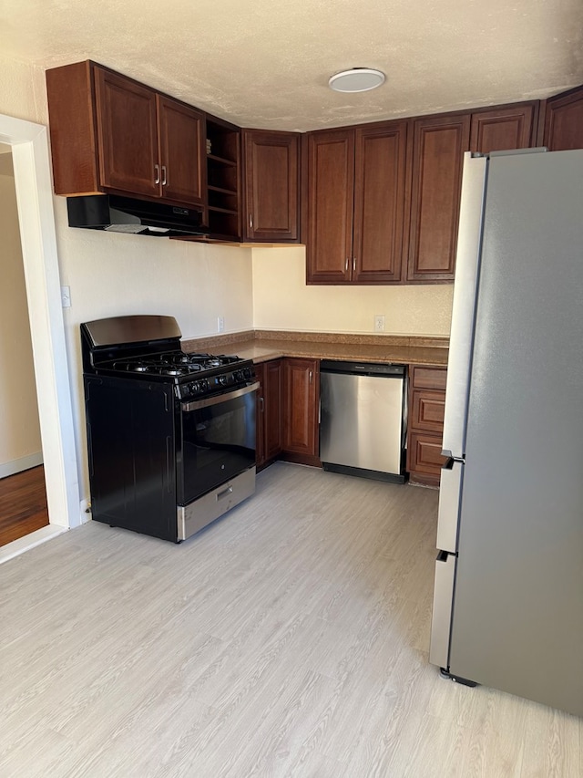 kitchen featuring light hardwood / wood-style flooring, extractor fan, a textured ceiling, and appliances with stainless steel finishes