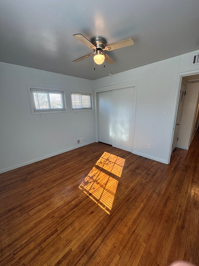 interior space with ceiling fan and dark wood-type flooring