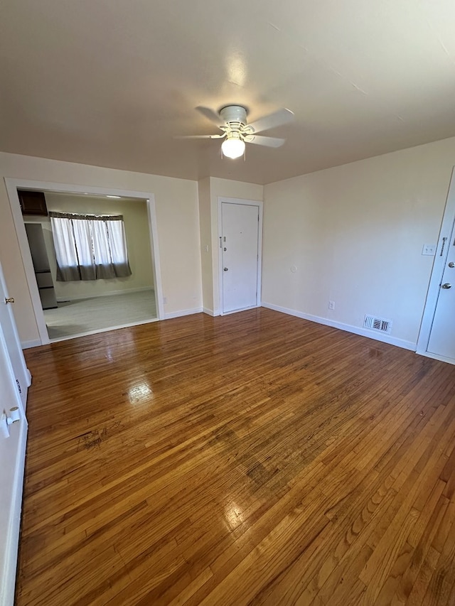 unfurnished living room featuring hardwood / wood-style flooring and ceiling fan