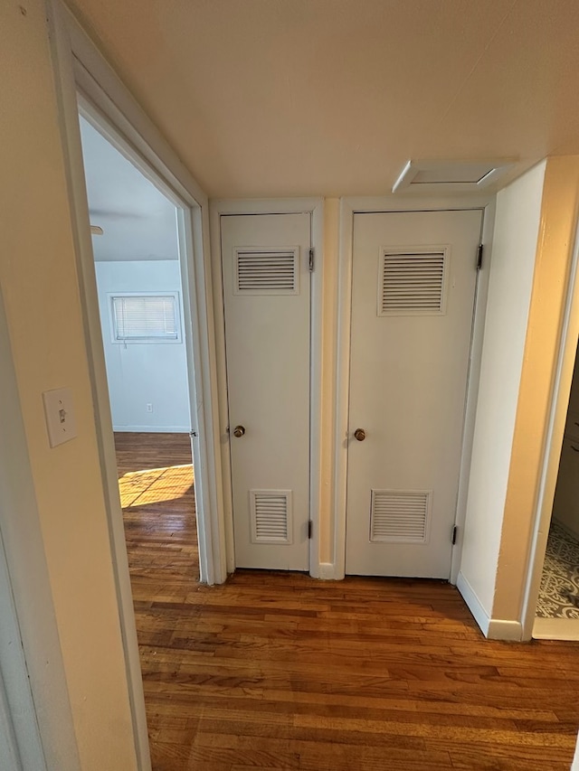 hallway with hardwood / wood-style flooring