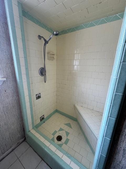 bathroom featuring tile patterned floors and tiled shower