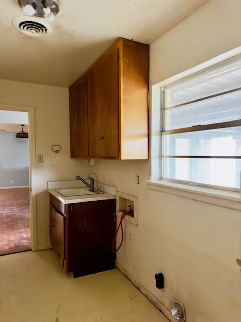 laundry area featuring hookup for a washing machine, cabinets, and sink