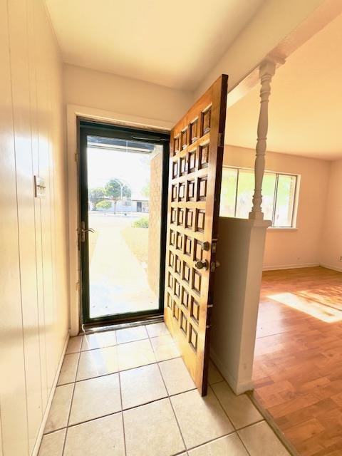 doorway to outside with a healthy amount of sunlight and light hardwood / wood-style floors