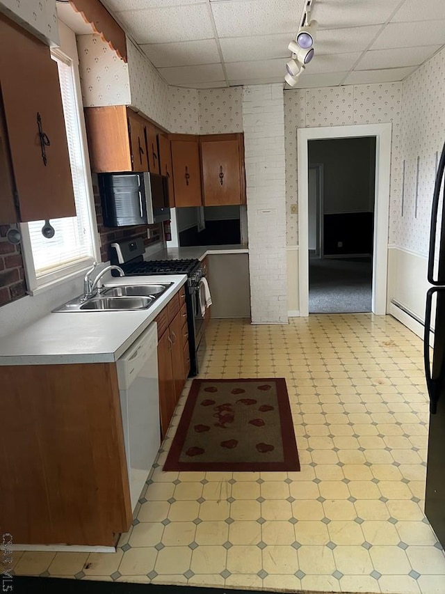 kitchen featuring stainless steel appliances, sink, track lighting, and baseboard heating