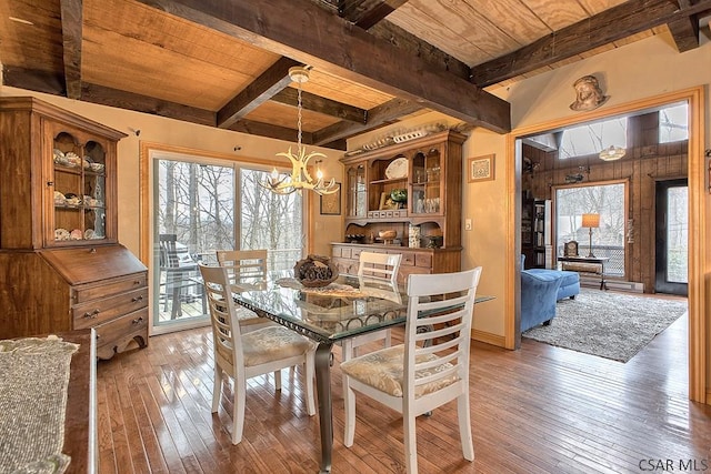 dining space with wood ceiling, light wood-style flooring, beamed ceiling, and a chandelier