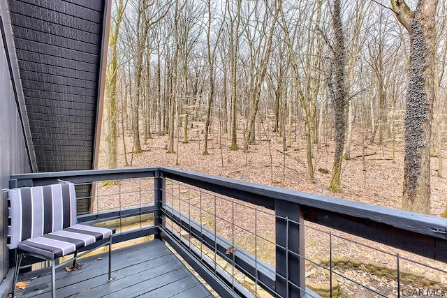 wooden deck with a forest view