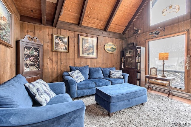 living area with wooden walls, wood finished floors, high vaulted ceiling, wooden ceiling, and beamed ceiling