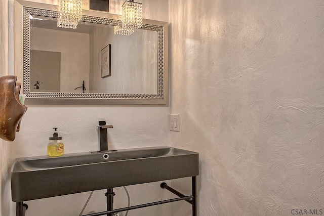 bathroom with a textured wall and a sink