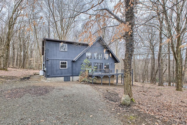 chalet / cabin featuring a deck and driveway